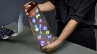 An image of a woman demonstrating the flexibility of LG Display's stretchable display