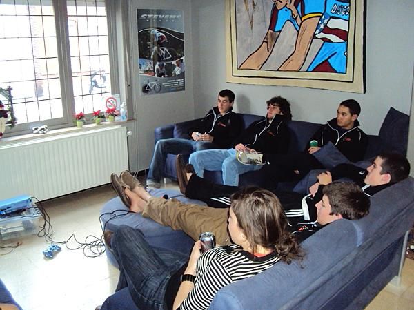 A group of people sitting around the couch watching the only English thing on TV which is the music video Chanel JIM (very very addicting and a definite good way of bonding with fellow team mates discussing how hot the singer is and who's the hottest of all etc etc)