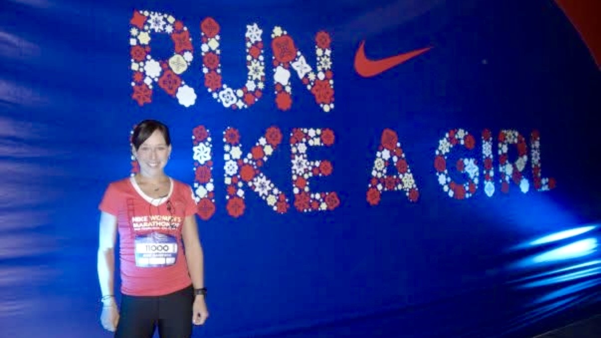 The article's author standing in front of a banner saying &amp;quot;Run like a girl&amp;quot;