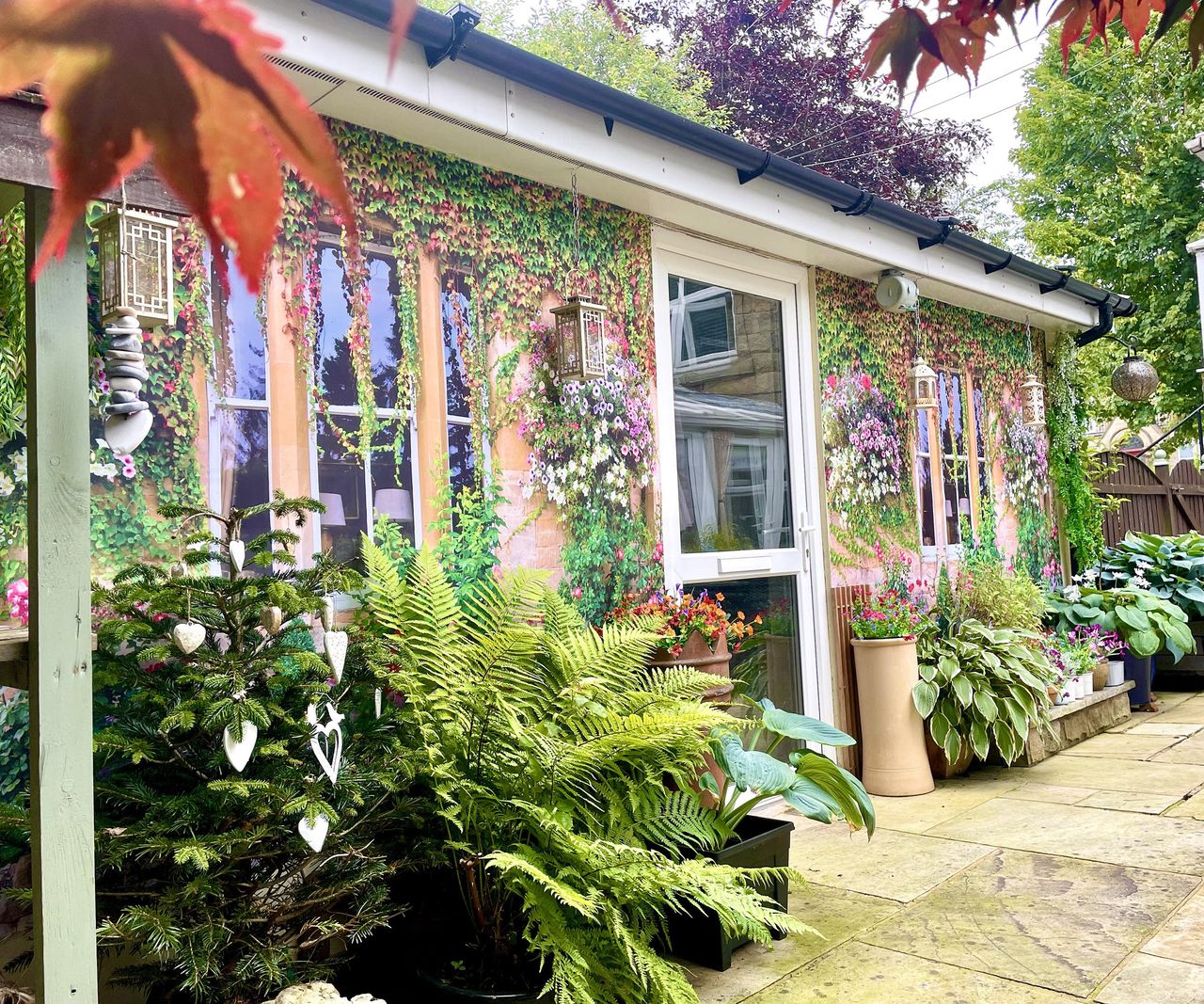 An exterior wall covered with two shower curtains with a nice window motif