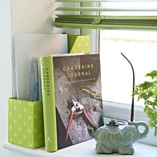 A windowsill with a cookbook and decorative objects