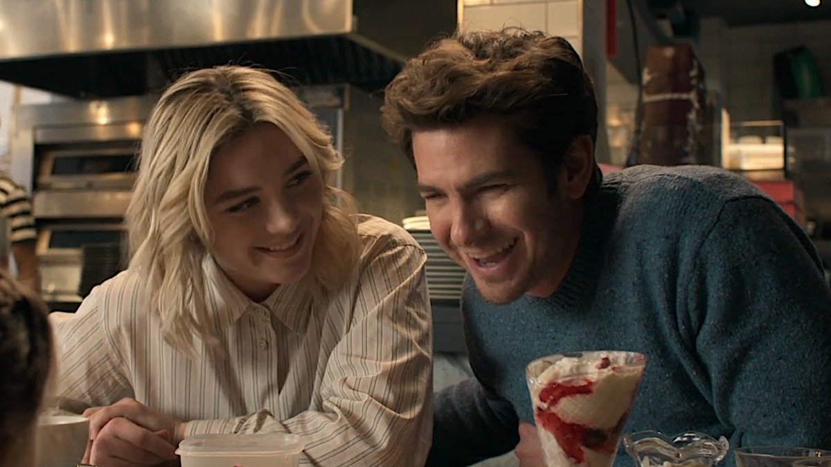 Florence Pugh and Andrew Garfield smiling together in We Live in Time