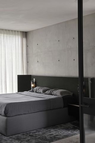 minimalist bedroom with concrete wall