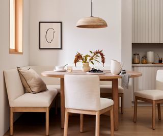 Kitchen with white furniture and dining table