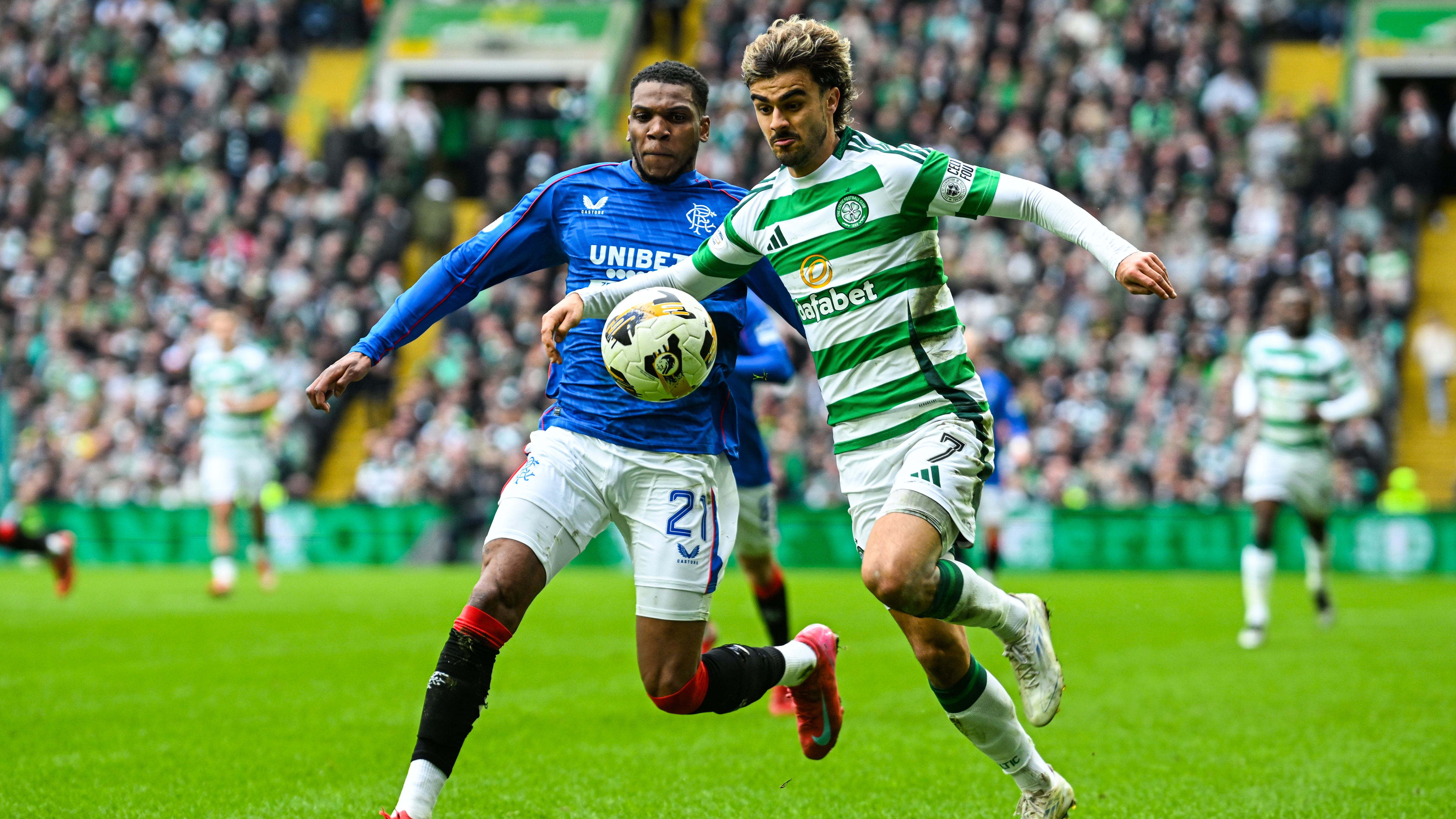 Dujon Sterling (left) and Jota (right) fight for the ball in the Celtic vs Rangers, Old Firm derby.