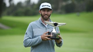 Dustin Johnson with the trophy after his victory in 2017