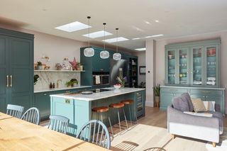 soft green kitchen island with rooflights above