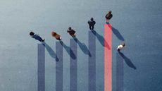 An overview of a bar chart with people standing at the tops of the bars. Some bars are taller than others, and one person falls short.