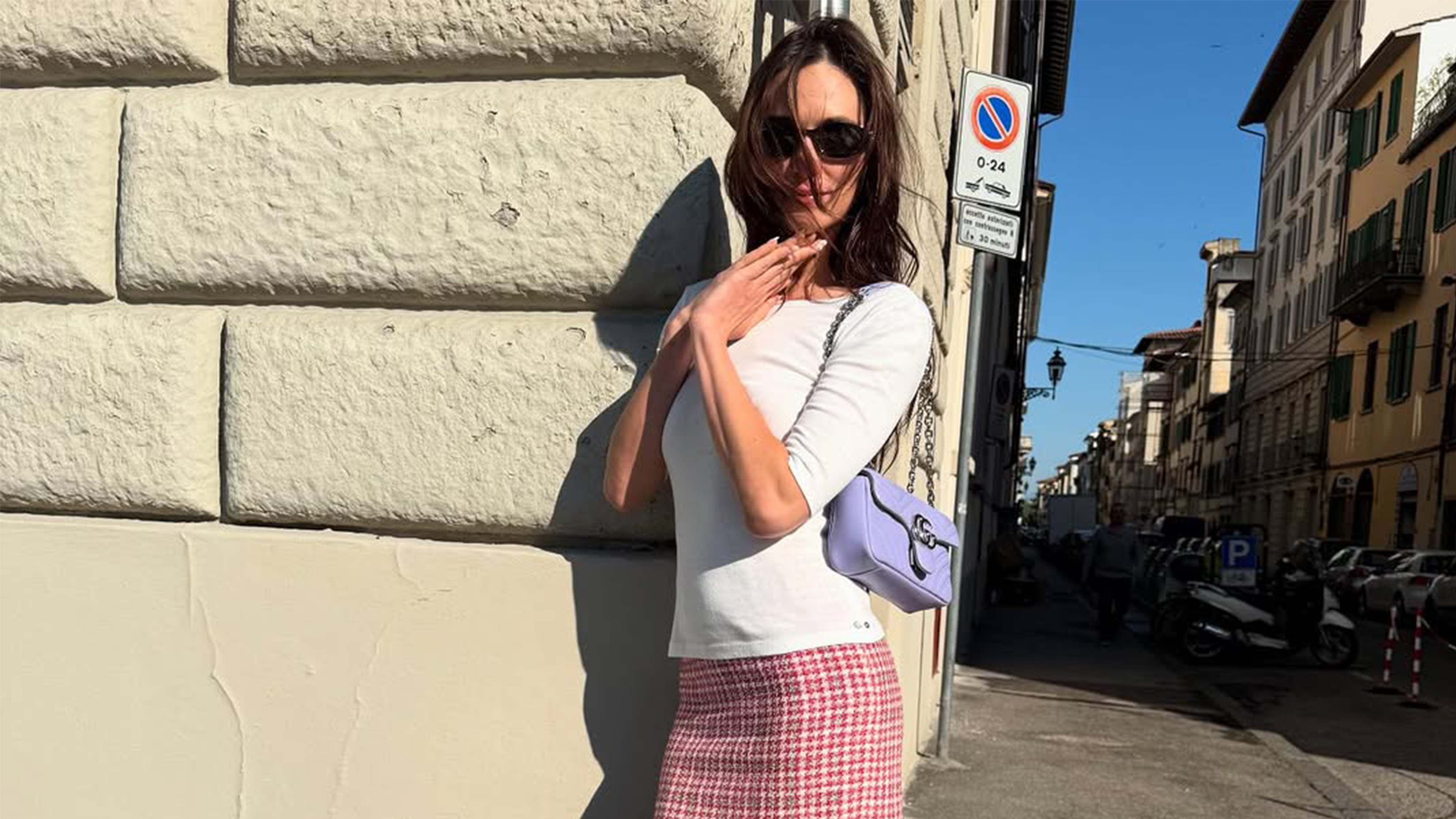@devonleecarlson wearing the t-shirt and knee-length skirt outfit trend of spring 2026.