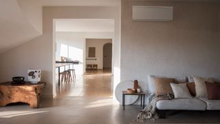 A Daikin Emura air to air heat pump unit on the wall of a beige room