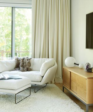 Allison Babcock neutral living room with white sofa, white curtains and deep pile white rug