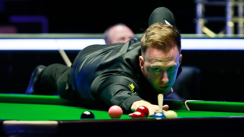 Judd Trump leans over the table to play a shot in a snooker match against Mark Williams. Both will play in the Riyadh Season Snooker Championship