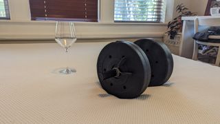 Testing the motion isolation of the Essentia Stratami mattress using an empty wine glass and 15 lb dumbbell
