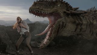 Karen Gillan stands in front of a roaring dinosaur in The Bubble.