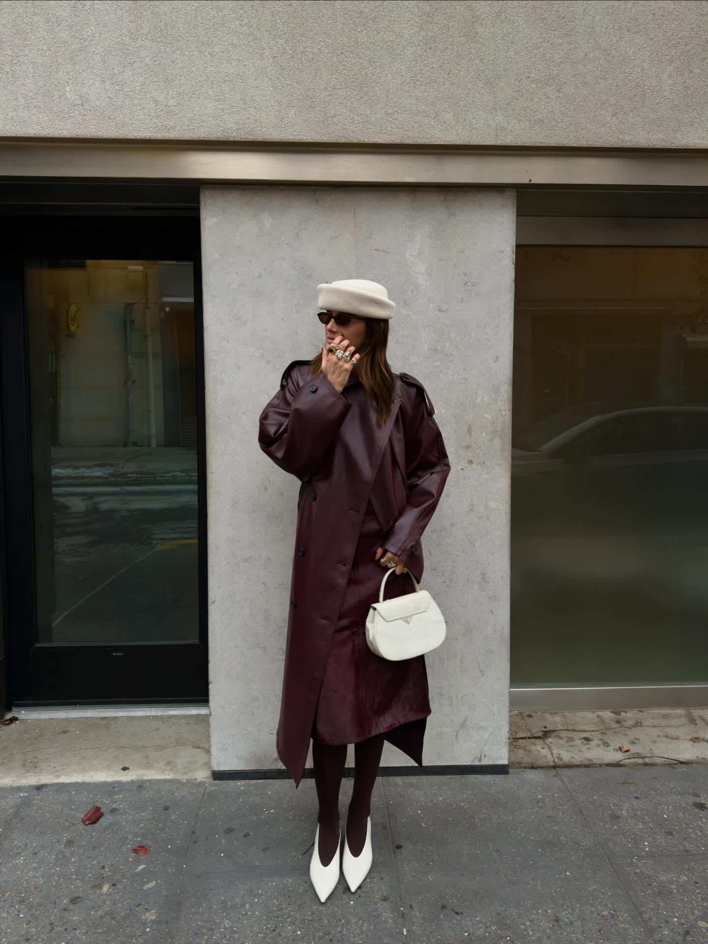 Woman wearing a burgundy winter outfit with white accessories.