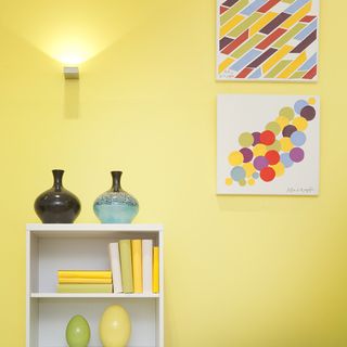 living room with yellow wall and white wooden shelves