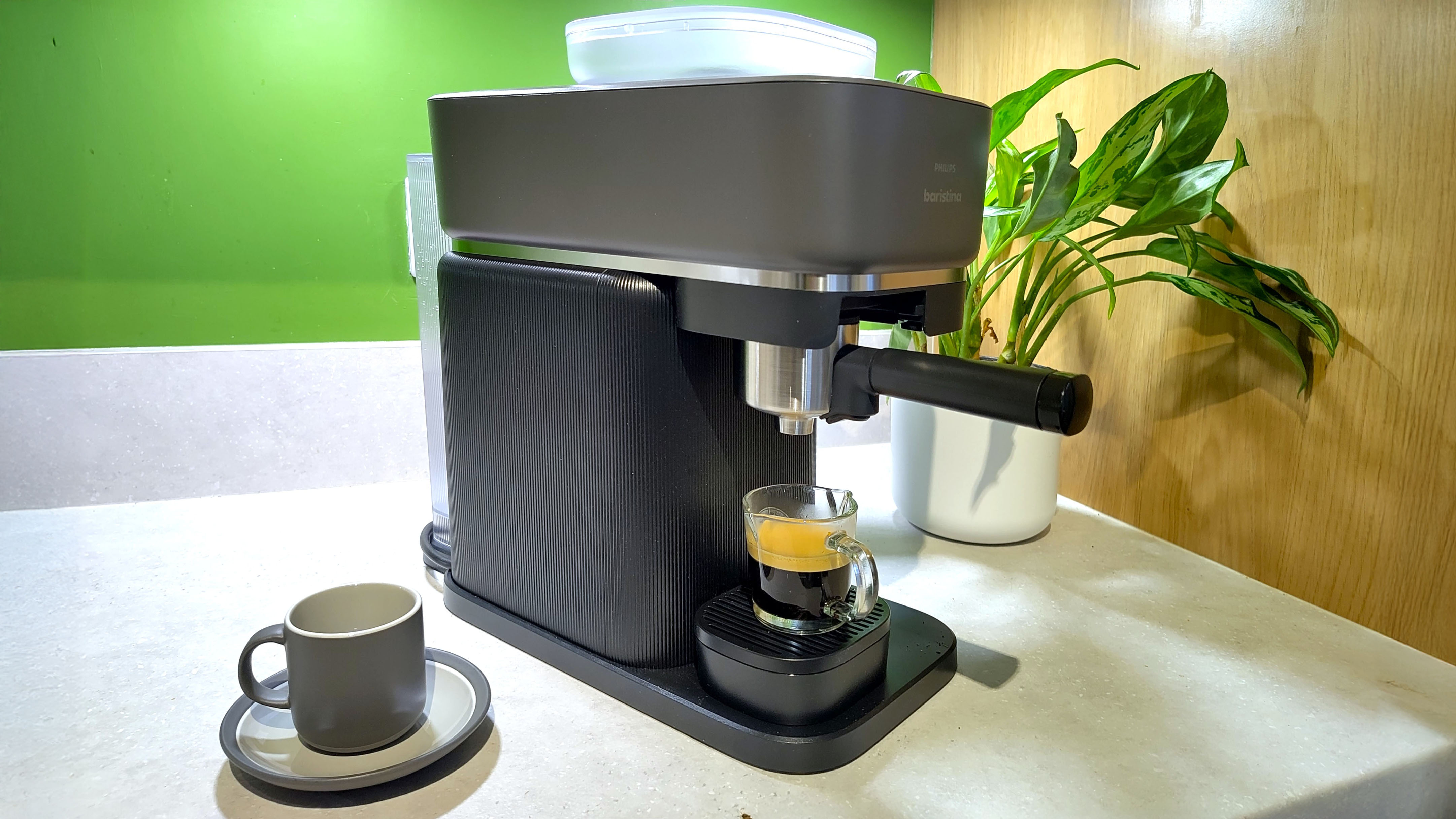 Philips Baristina coffee maker with espresso on kitchen counter