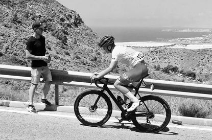 Juan Pujalte cycling in a black and white image