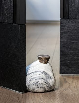 Stone and bronze doorstop made from upcycled materials