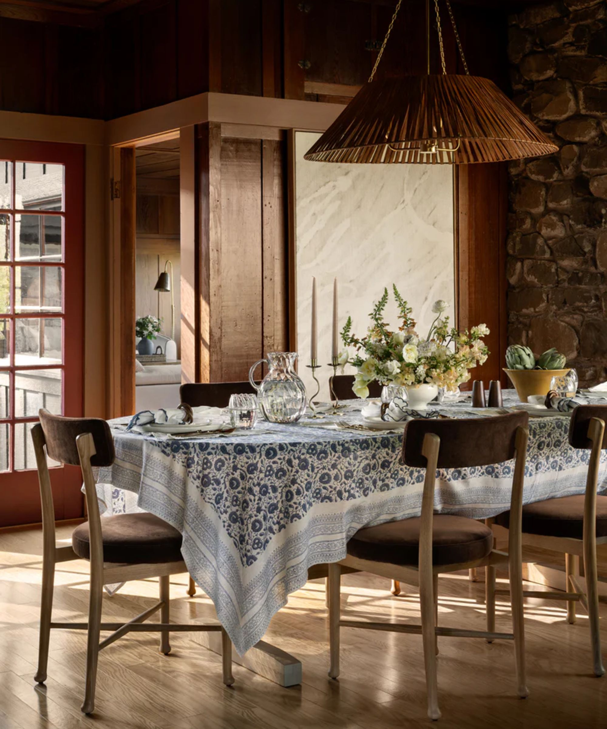 Tablescape with blue floral tablecloth and spring flower centerpiece