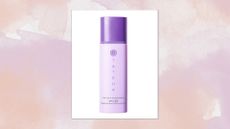 A close-up of the Tatcha The Silk Sunscreen SPF 50/ in a beige and purple watercolour paint-style template