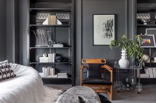 Charcoal gray living room with bookshelves