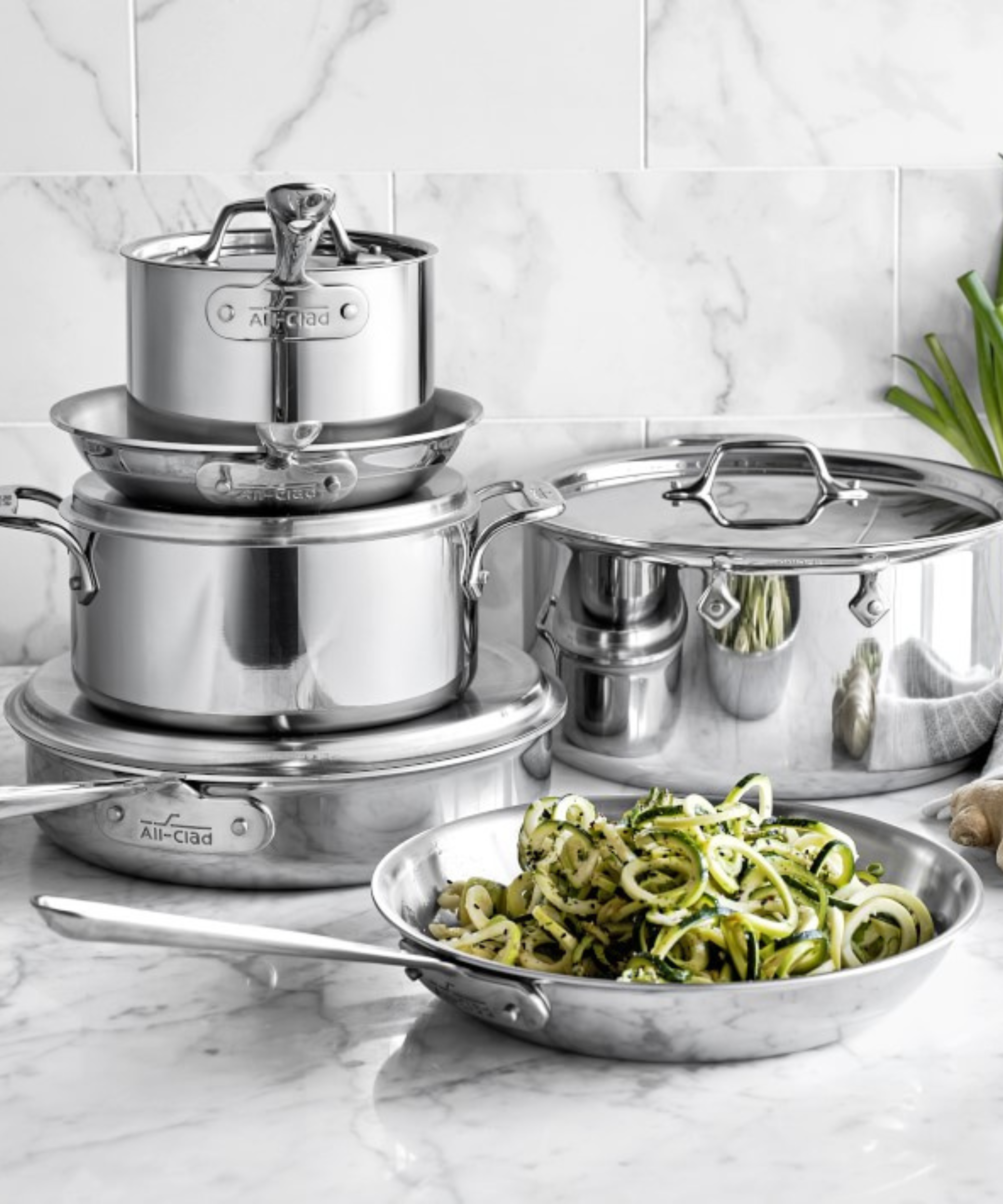 A collection of stainless steel All-Clad pans