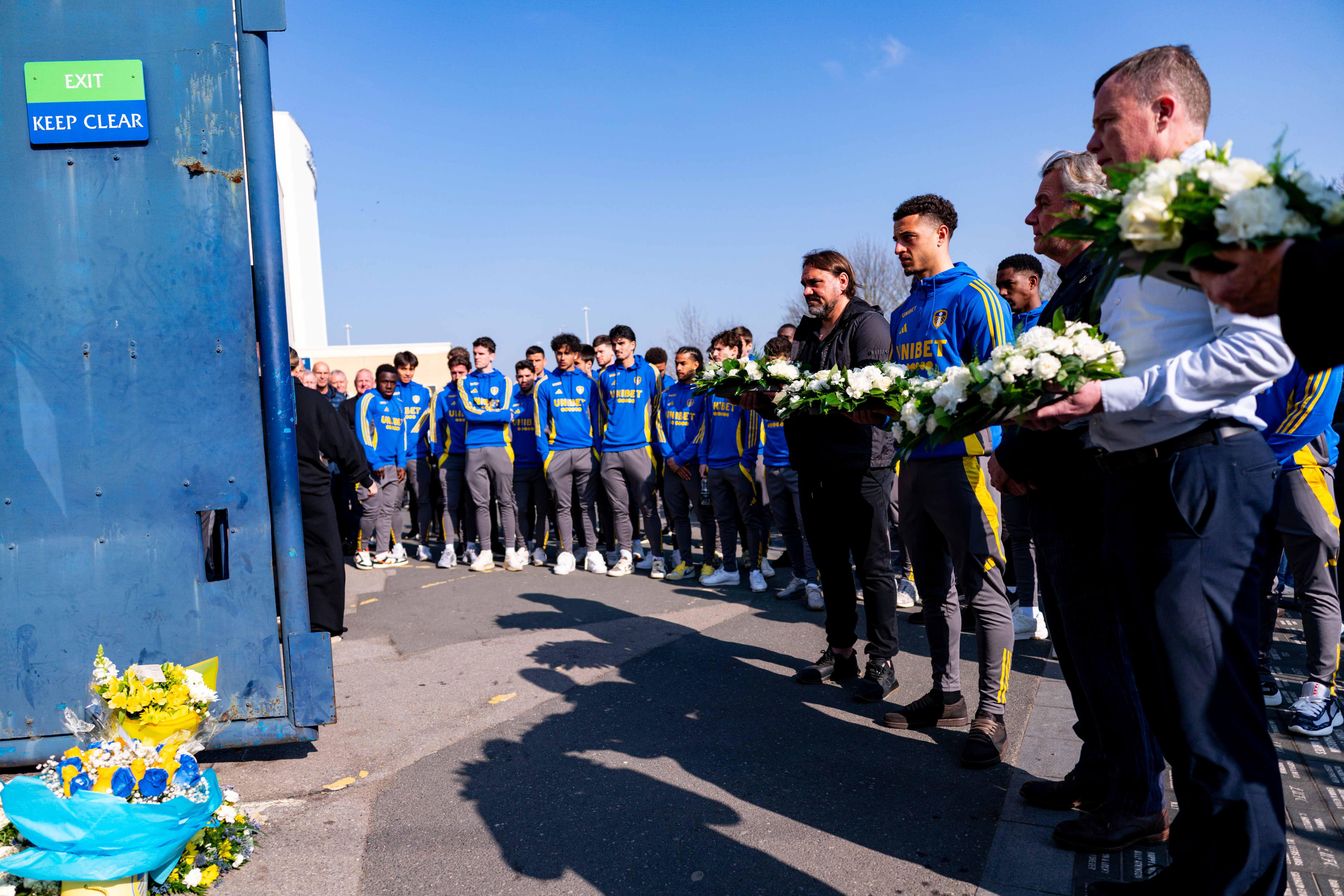 LEEDS, ENGLAND - APRIL 3: Daniel Farke of Leeds United and Ethan Ampadu of Leeds United lay wreaths and pay their respects as Leeds United hold a Memorial in Honour of the 25th Anniversary of the Passing of Christopher Loftus and Kevin Speight at Elland Road on April 3, 2025 in Leeds, England. (Photo by Malcolm Bryce/Leeds United via Getty Images)