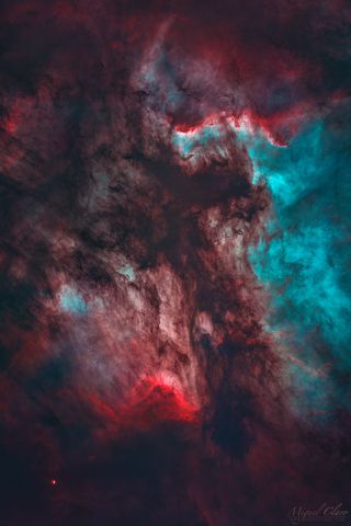 a colorful cloud of gas seen among bright background stars