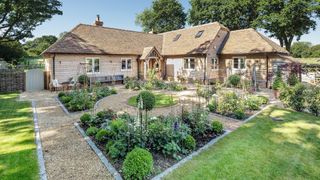 traditional gravel garden with lawned area outside timber clad self build