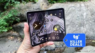 Pixel Fold held in the hand with badge nearby.