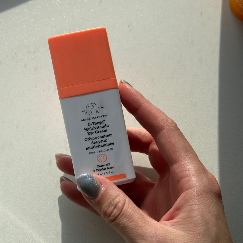 Grace holding the Drunk Elephant C-Tango Multivitamin Eye Cream