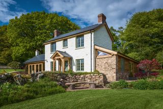 oak frame side extensions to rendered cottage