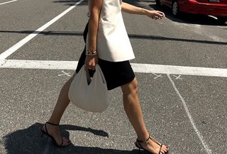 Woman wearing minimalistic black heeled sandals.