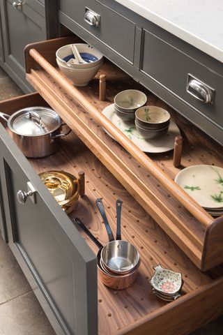 Interior of kitchen pan drawer with pegboard dividers by Smallbone of Devizes