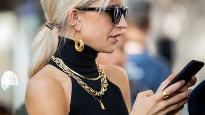 Caroline Caro Daur seen wearing jewellery: golden earrings, necklace and ring, sunglasses outside Sacai during Paris Fashion Week Womenswear Spring Summer 2020 on September 30, 2019 in Paris, France. 