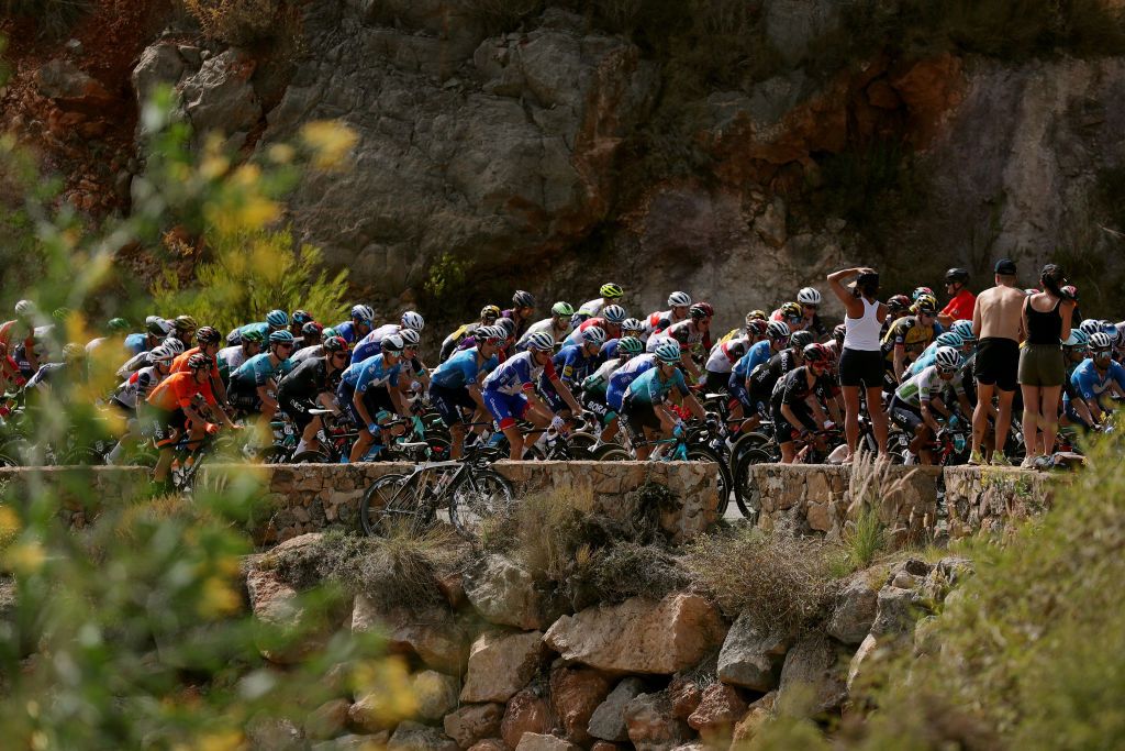 LA MANGA SPAIN AUGUST 21 A general view of the peloton compete while fans cheer during the 76th Tour of Spain 2021 Stage 8 a 1737 km stage from Santa Pola to La Manga del Mar Menor lavuelta LaVuelta21 on August 21 2021 in La Manga Spain Photo by Gonzalo Arroyo MorenoGetty Images