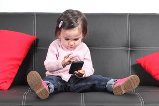 toddler playing on smartphone