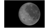 A new photo captures the moon's near side on the right (the side we see from Earth, identifiable by its dark splotches) and its far side on the left. The Artemis 2 crew are the first to see the far side with human eyes.