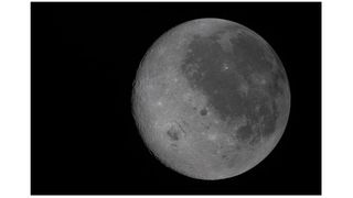 A new photo captures the moon's near side on the right (the side we see from Earth, identifiable by its dark splotches) and its far side on the left. The Artemis 2 crew are the first to see the far side with human eyes.