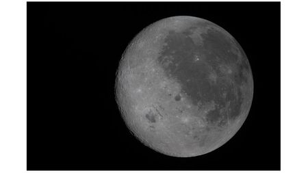 A new photo captures the moon's near side on the right (the side we see from Earth, identifiable by its dark splotches) and its far side on the left. The Artemis 2 crew are the first to see the far side with human eyes.