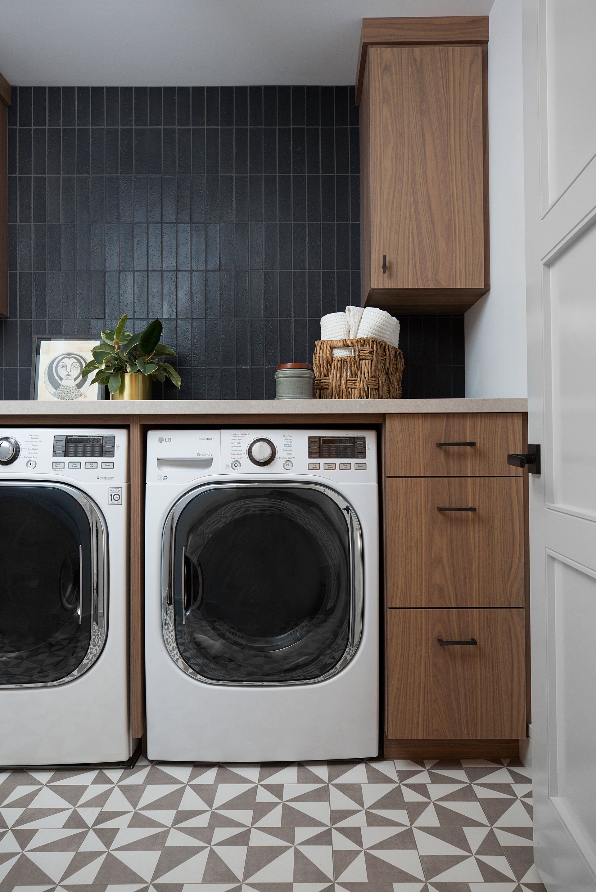 Utility room with dark walls and wooden cabinetry
