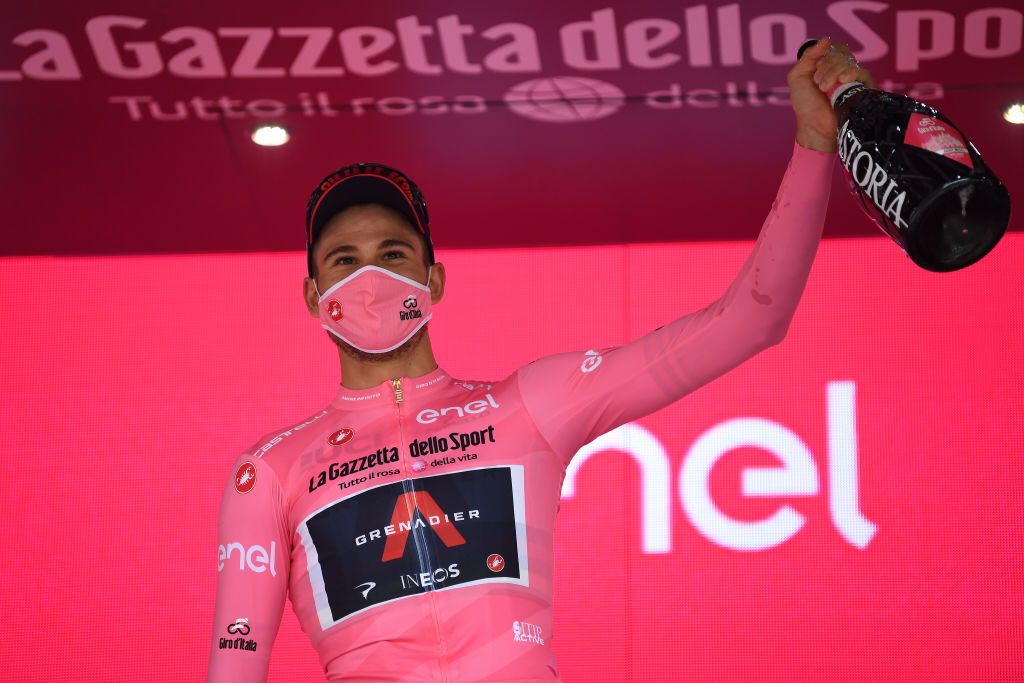 PALERMO ITALY OCTOBER 03 Podium Filippo Ganna of Italy and Team INEOS Grenadiers Pink Leader Jersey Celebration Mask Covid safety measures Champagne Flowers during the 103rd Giro dItalia 2020 Stage 1 a 151km Individual Time Trial stage from Monreale to Palermo ITT girodiitalia Giro on October 03 2020 in Palermo Italy Photo by Tim de WaeleGetty Images