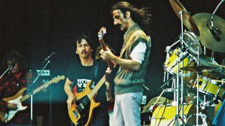 Frank Zappa performs on stage with band members Denny Walley and Arthur Barrow, at The Knebworth Festival on September 9th, 1978 in Knebworth, United Kingdom.