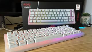 Cherry XTRFY K5V2 keyboard on a wooden desk with box in the background
