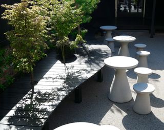 Cast-concrete stools and tables provide additional mushroom-like seating and surfaces.