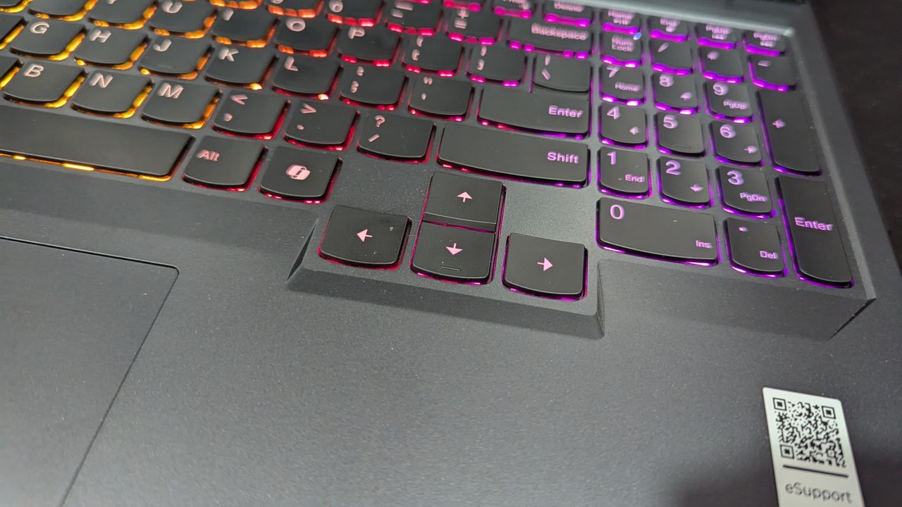 Lenovo Legion Pro 5i open on a black desk with the camera focused in on the arrow keys on the keyboard.