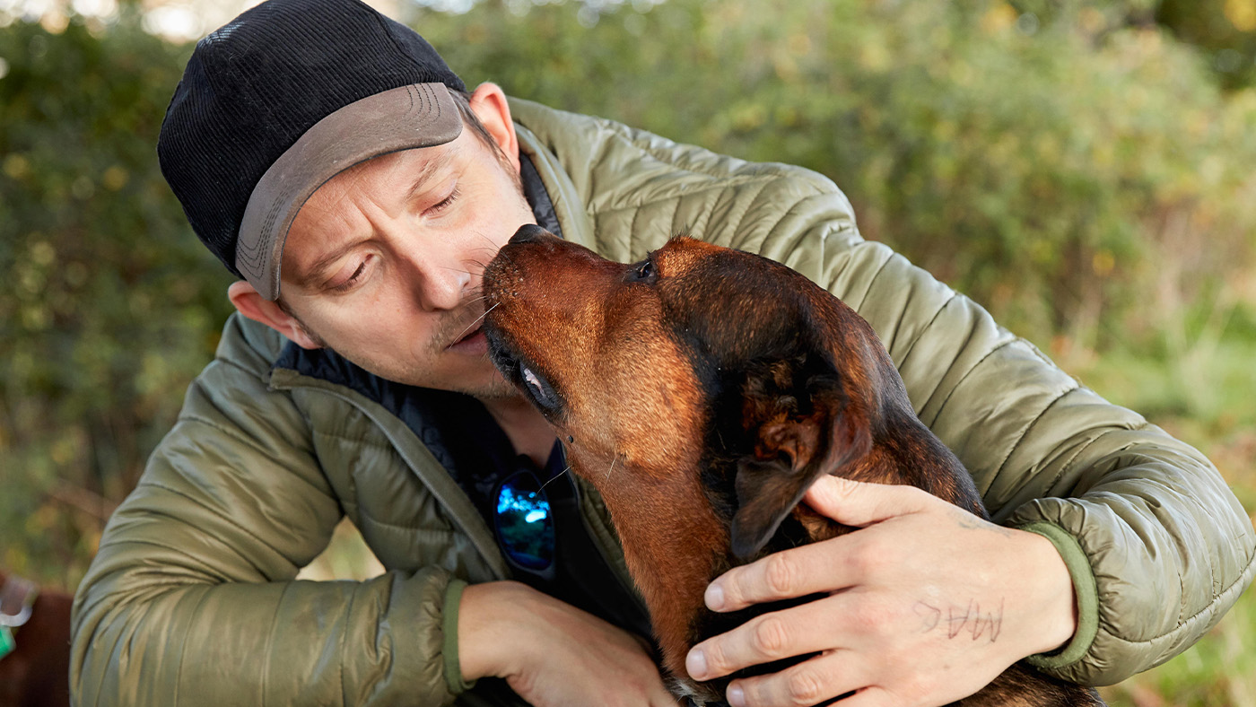 Dog nuzzling owner