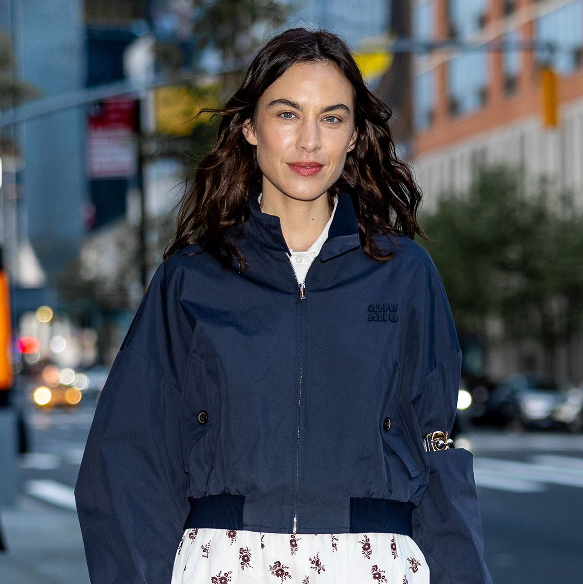 Alexa Chung wearing a navy Miu Miu bomber jacket