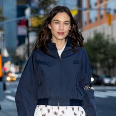 Alexa Chung wearing a navy Miu Miu bomber jacket